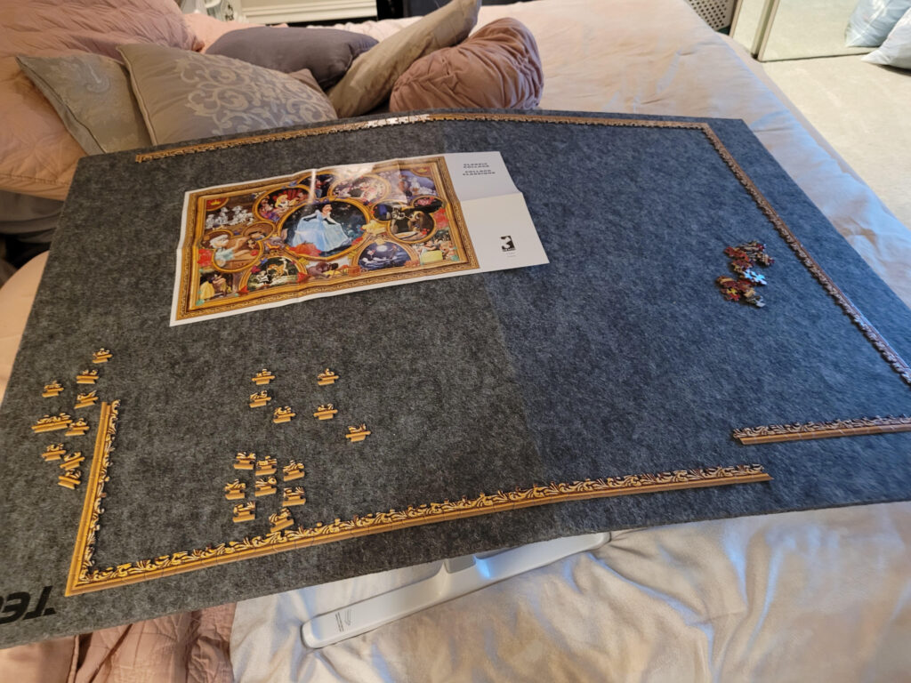 Starting a new puzzle — a relaxing way to enjoy puzzling as a hobby — a puzzle board with a recently started 2000 piece Ceaco Disney puzzle